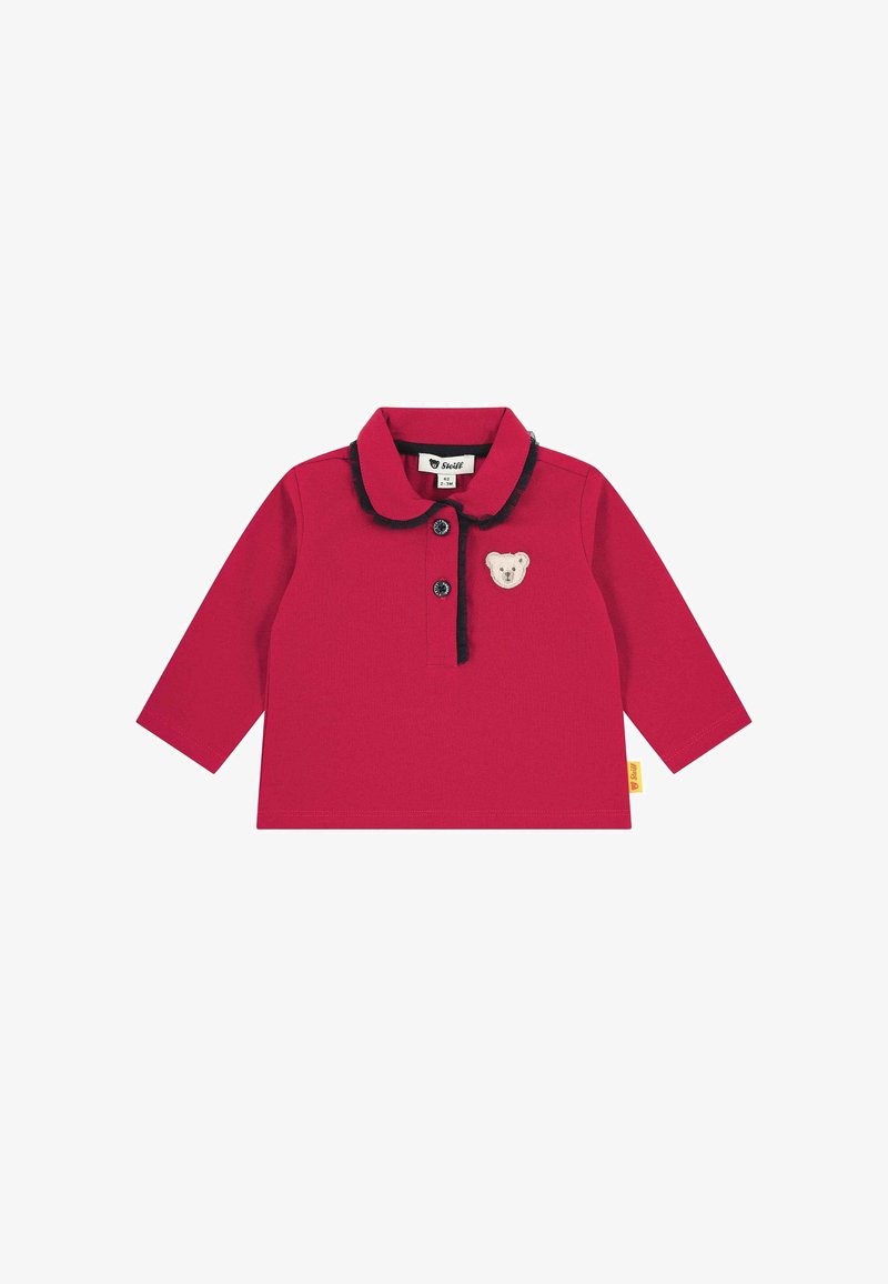 Red long-sleeve baby shirt with black-trimmed collar, two black buttons, and a small beige bear patch on the chest.