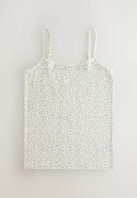 Vit linne med grå leopardmönster, har tunna justerbara spännen, en avslappnad design och en slät, mjuk textur.
