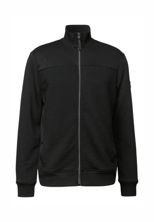 Schwarze Reißverschlussjacke aus strukturiertem Material. Hoher Kragen, zwei seitliche Taschen, gerippte Bündchen und Saum mit einem einfarbigen Design.