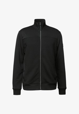 Chaqueta negra con cremallera, fabricada en un material texturizado. Cuello alto, dos bolsillos laterales, puños acanalados y dobladillo inferior con un diseño de color sólido.