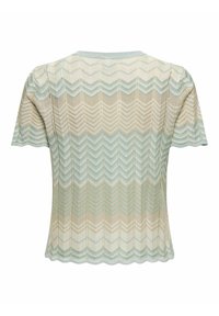 Short-sleeve knitted top in beige and blue hues with a zigzag pattern. Features a scalloped hem and textured fabric.