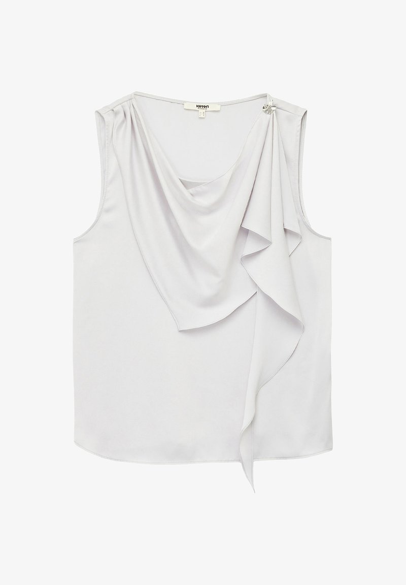 Draped light gray sleeveless top made of smooth fabric, featuring cascading ruffles and a decorative embellishment on one shoulder.