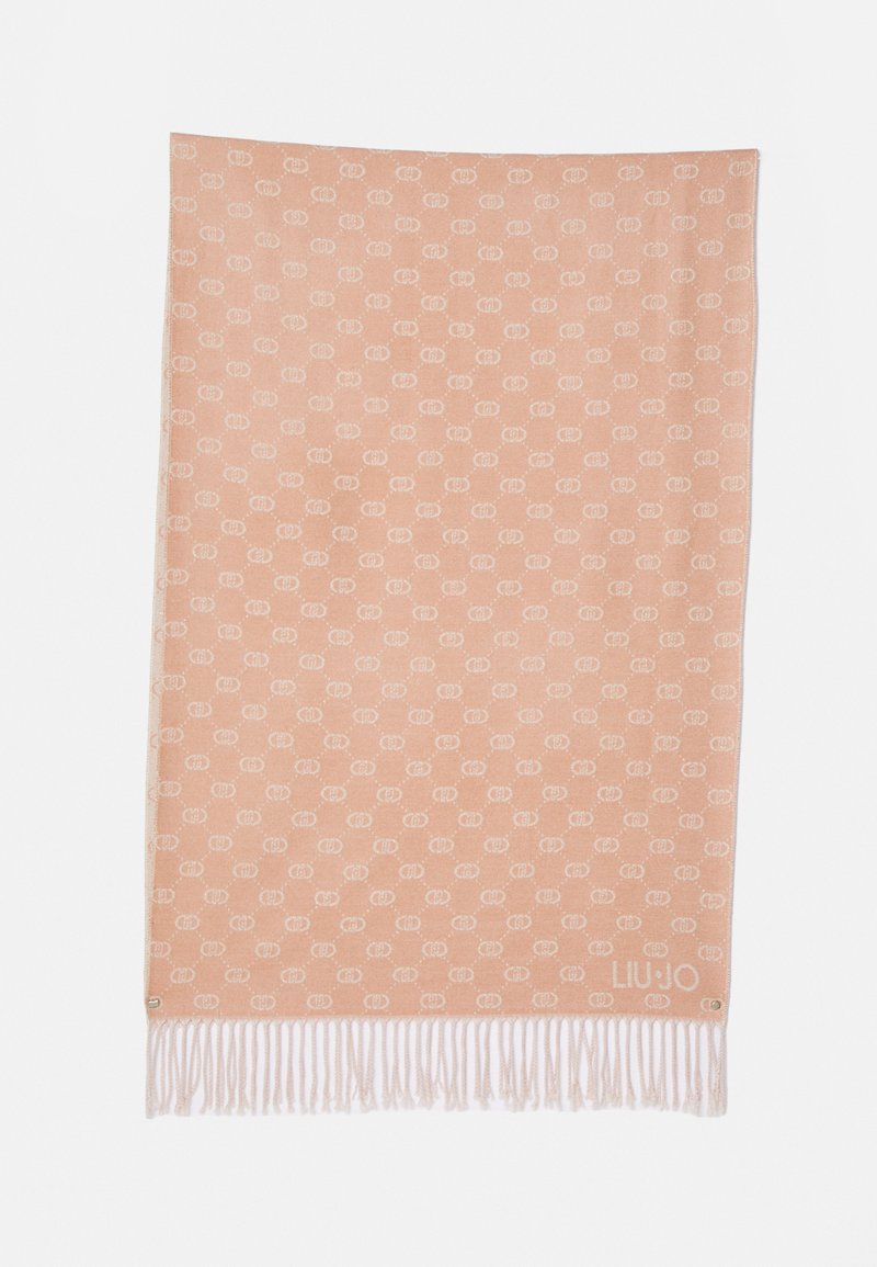 Coperta color pesca con motivo a logo bianco, rifinita con frange bianche nella parte inferiore. Texture morbida, forma rettangolare.