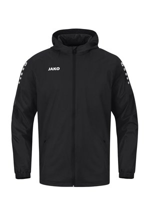 Veste de sport noire à capuche avec fermeture éclair complète à l’avant, poignets élastiques, logo JAKO sur la poitrine et motif circulaire sur les deux manches.