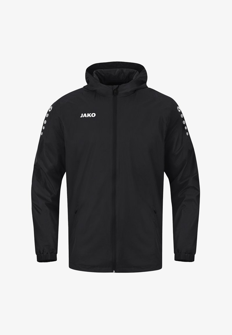 Veste de sport noire à capuche avec fermeture éclair complète à l’avant, poignets élastiques, logo JAKO sur la poitrine et motif circulaire sur les deux manches.