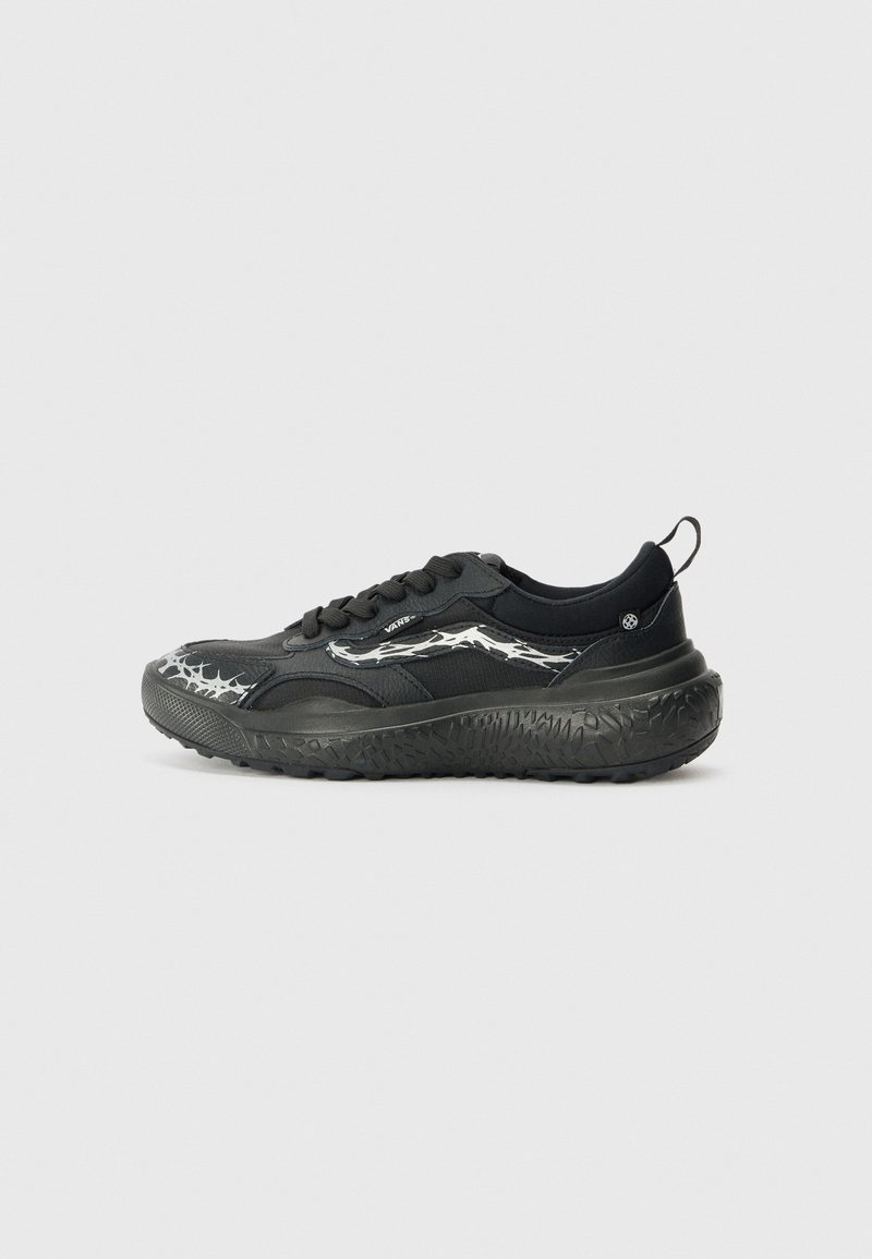 Scarpa sportiva nera con una suola nera texturizzata, dettagli argentati e una tomaia liscia caratterizzata da un audace motivo grafico.