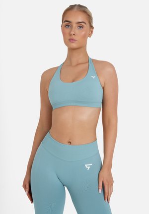Light blue sports bra and matching leggings made from textured, stretchy fabric. Sports bra features a racerback design and logo accent.