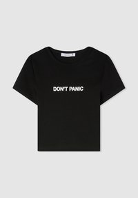 T-shirt nera a maniche corte in cotone, con testo bianco che recita "DON'T PANIC" sul petto. Collo a giro classico.
