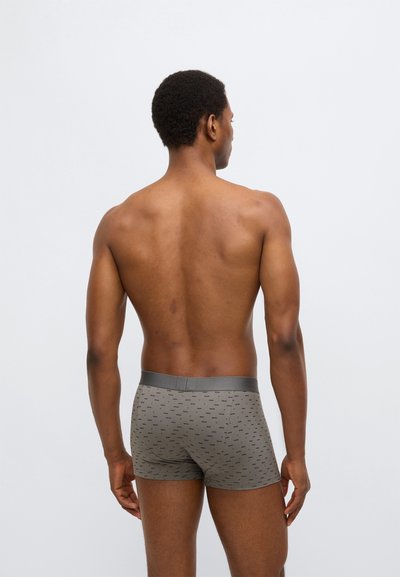 Graue Boxershorts mit einem dezenten Muster, elastischem Bund und einer körpernahen Passform. Das Material wirkt weich und dehnbar und sorgt für Komfort.