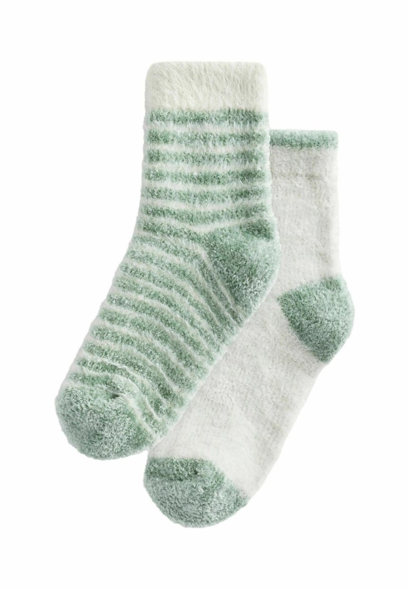 Ett par mjuka strumpor: en mintgrön med vita ränder, den andra helt vit med mintgröna detaljer på hälen och tån. Plyschig textur.