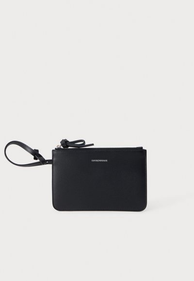 Μαύρο τσαντάκι καρπού Emporio Armani με κλείσιμο με φερμουάρ και λαβή λουρί στο λευκό φόντο.