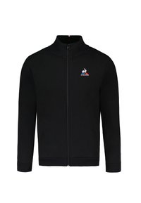 Giacca nera con zip e colletto alto, caratterizzata da un piccolo logo sul petto sinistro e tasche laterali. Texture liscia, polsini a costine.