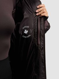 Black quilted jacket with a zippered front, featuring a logo patch in white and a smooth, shiny texture on the interior lining.