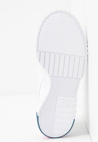 White athletic shoe sole with textured rubber, featuring ridges and a blue accent. The logo is embossed on a square section of the sole.