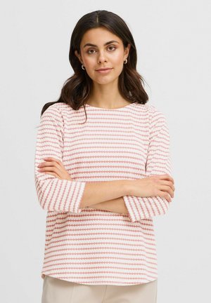 Long-sleeve top in light pink and white with horizontal stripes. Soft fabric features round dots in varying sizes and colors.