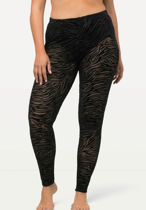 Zwarte leggings van doorschijnende, gestructureerde stof met een zebrapatroon. Heeft een hoge taille en een aansluitende pasvorm, die de benen bedekt.