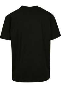 Tricou din bumbac negru cu mâneci scurte. Design cu guler rotund, croială lejeră, textură netedă, fără cusături sau modele vizibile pe spate.