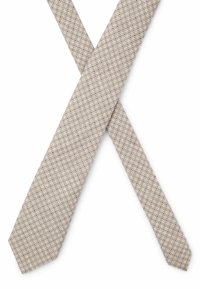 Smalle beige das met een herhalend geometrisch patroon van kleine donkere cirkels, gemaakt van een gladde stof met een lichte glans.