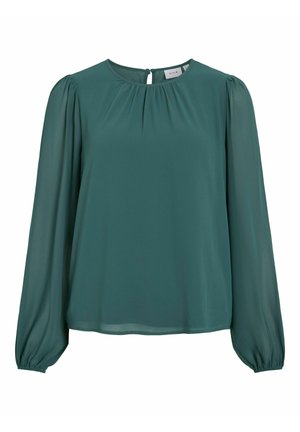 Roheline, pikkade varrukatega bluus, mis on valmistatud kergest kangast, ümarate dekoltee ja kroogitud detailidega ning elastsete mansettidega. Seljal on võtmeaugu sulgemine.