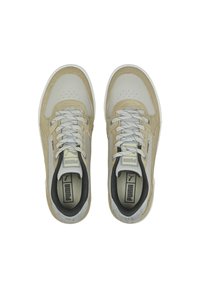 Beige and gray athletic shoes featuring leather and suede materials, round toe, perforated detailing, and gray laces on a textured white sole.