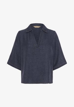 Top scurt de culoare albastru închis, cu un finisaj texturat, având o guler V și cusături galbene în contrast pe margini.