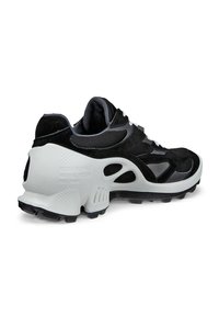 Black and gray athletic shoe with a textured mesh upper, padded collar, and white rubber sole featuring a pattern of traction studs.