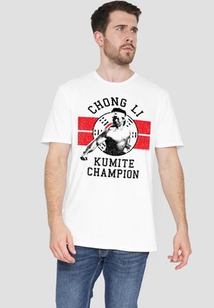 White cotton t-shirt featuring a graphic print of a martial artist with the text "CHONG LI KUMITE CHAMPION" and red design elements.