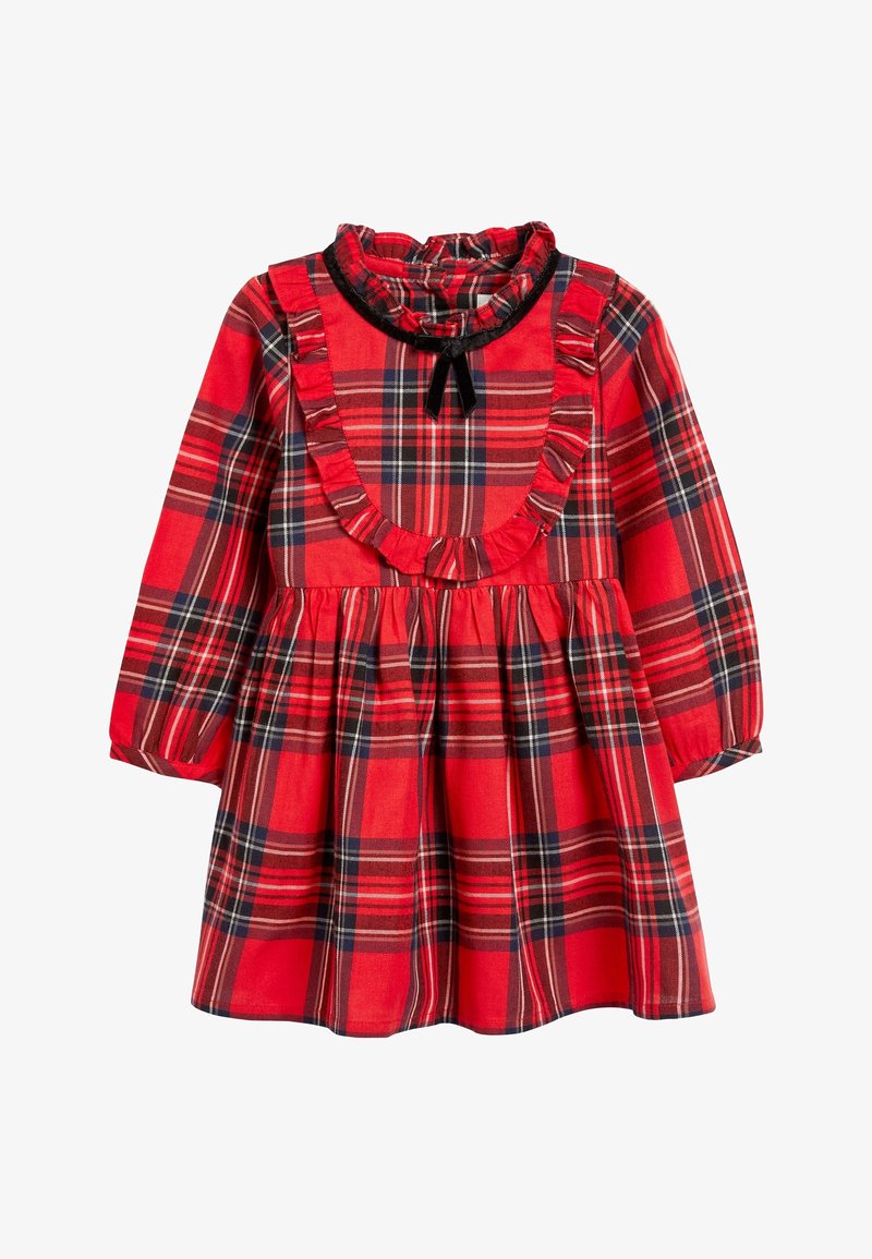 Robe à carreaux rouges avec des manches longues, un col froncé et une taille cintrée avec une jupe évasée. Noeud noir en accent au niveau du col.