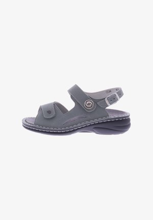 Gray open-toe sandal featuring a suede-like material, adjustable straps, decorative swirl accent, and a cushioned black sole.