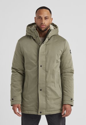 Olive green parka jacket featuring a hood, zip closure, and black snap buttons. The interior has a soft, textured lining.