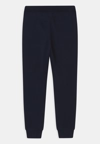 Navy sweatpants with a slim fit, made from soft fabric, featuring an elastic waistband and ribbed cuffs at the ankle. No patterns or accents.