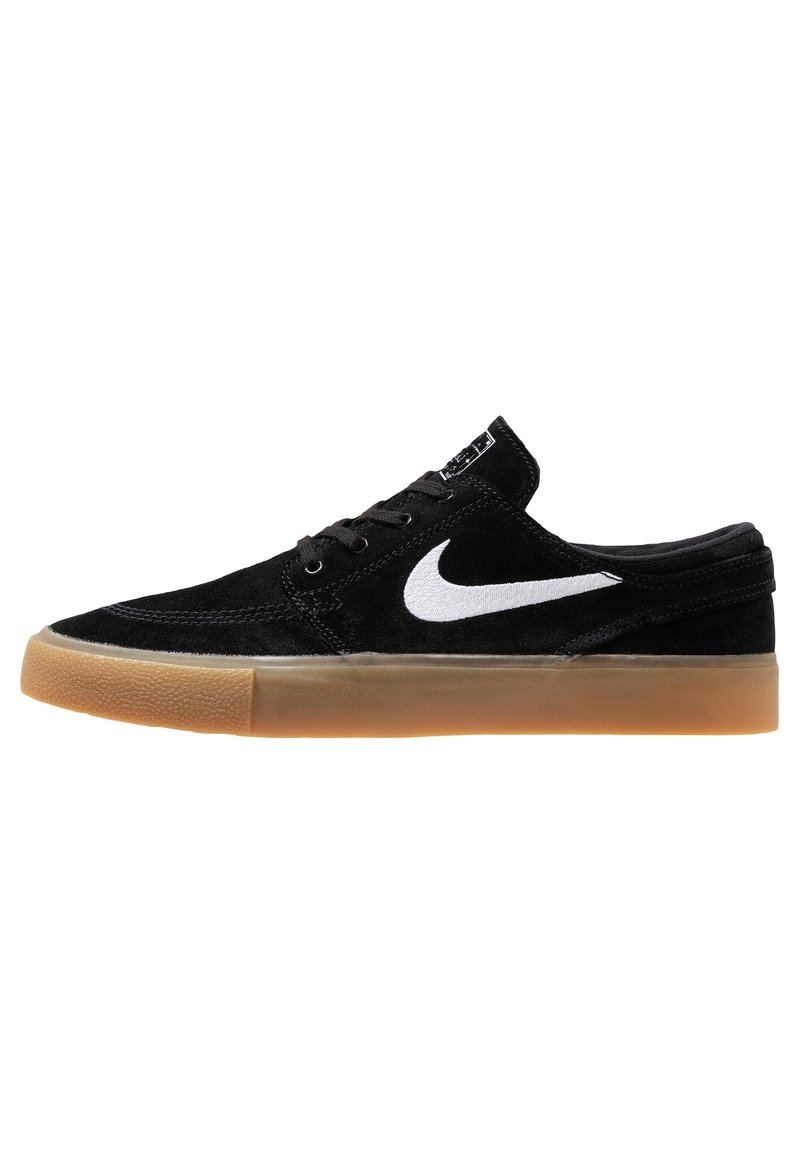 Scarpe da skate in suede nere con il logo Nike bianco, suola in gomma naturale, design a profilo basso e chiusura con lacci. Dettagli sulla superficie texturizzati.
