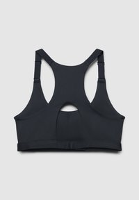 Top sportivo nero con design a schiena scoperta, tessuto testurizzato, spalline regolabili e un'apertura a chiave sul retro per la ventilazione.