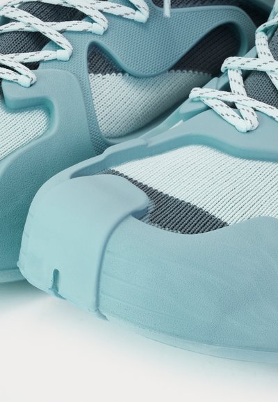 Aqua blue athletic shoes featuring a textured mesh upper and rubber overlays, with gray accents and white laces for secure fit.