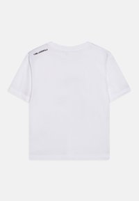 T-shirt bianca in cotone con maniche corte, vestibilità comoda, con ricamo nero "KARL LAGERFELD" sulla schiena vicino al collo.