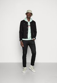 Puma PUMA HARIBO HOODIE - Felpa - gossamer green