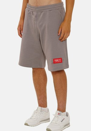 Gray cotton blend shorts with an elastic waistband, side pockets, and a red logo patch on the left thigh. Knee-length design.