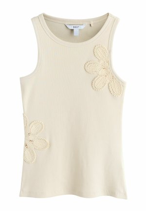 Ujjatlan bézs bordázott trikó, horgolt virágos díszítésekkel a jobb felső mellrészen és az alsó bal oldalon.