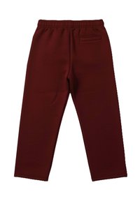 Bordeauxrode joggingbroek gemaakt van zachte stof, met een elastische tailleband en een achterzak met minimale stikseldetails.