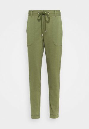 Pantalons de jogging verts en tissu doux, avec une taille à cordon de serrage, deux poches latérales et une jambe fuselée avec des bracelets retournés.