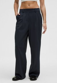 Navy wide-leg trousers made of a smooth fabric, featuring a high waist, two side pockets, and belt loops for adjustability.