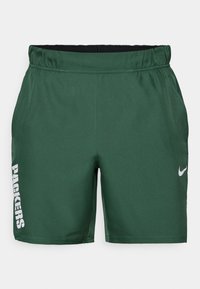 Zaļie sporta šorti, kas izgatavoti no gludas auduma. Iezīmē elastīgs jostasvieta, drukāts "PACKERS" logo baltā krāsā un Nike svītra pelēkā krāsā.