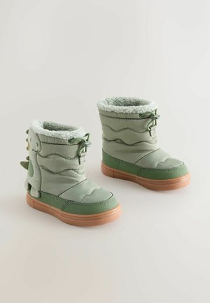 Grüne gepolsterte Stiefel mit strukturierter Oberfläche, Fleece-Innenauskleidung und Gummisohle. Verfügt über ein Dinosaurierdesign mit Stacheln an der Seite.