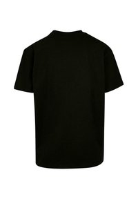 T-shirt noir à manches courtes en coton. Il présente un col rond et une coupe décontractée, une texture lisse et un design arrière uni.