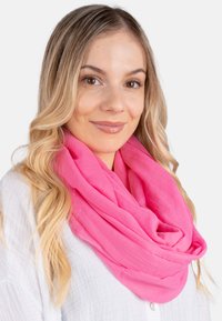 Pink lightweight scarf made of soft, sheer fabric, styled in a loop around the neck, with a smooth texture and flowing design.