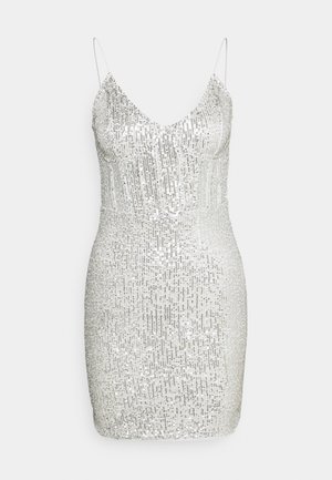 White sleeveless mini dress covered in vertical rows of silver sequins with thin spaghetti straps and a V-neckline.