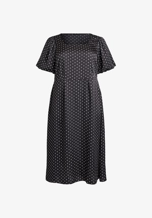 Robe noire mi-longue à pois blancs, manches courtes bouffantes et encolure carrée.