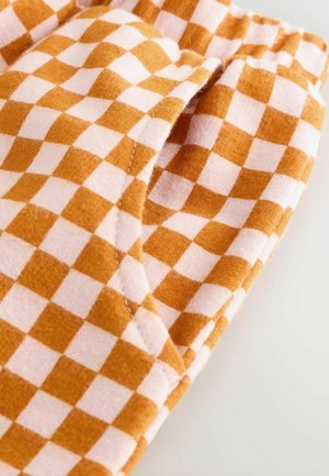 Baumwollstoff in einem karierter Muster mit orangen und rosa Quadraten. Enthält eine Seiten- tasche mit sichtbaren Nähdetails.