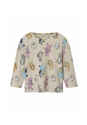 Chemise à manches longues, beige, avec une texture côtelée ornée de motifs d'animaux de cartoon colorés. Encolure ronde et coupe décontractée.