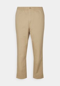 Beiga bomullsbyxor med elastisk midja och knappstängning, med raka ben och minimala sömnadsdetaljer.
